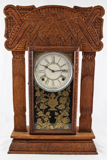 Late 19th century American pressed Oak case gingerbread clock by E. Ingraham Clock Co