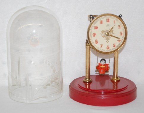 Swinging Doll Dome Clock