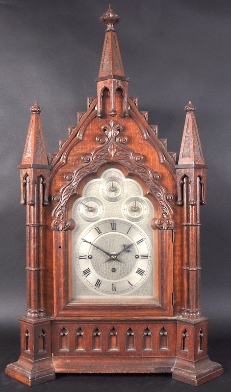 A GOOD VICTORIAN GOTHIC OAK BRACKET CLOCK AND BRACKET,