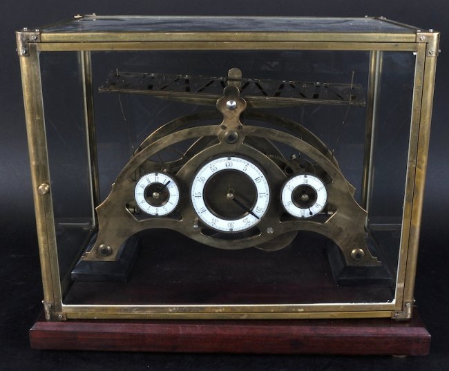 A ROLLING BALL CLOCK IN A GLASS DOME, 14 inches long.