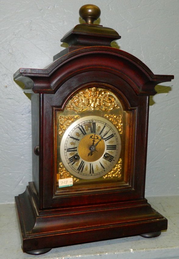 Junghans 8 day walnut mantle clock w/cherubs.