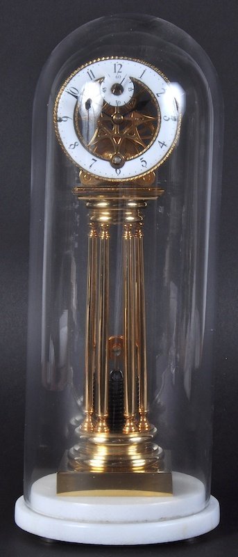 A TRIGOMA BRASS SPRING FUSEE CLOCK in a glass dome on a