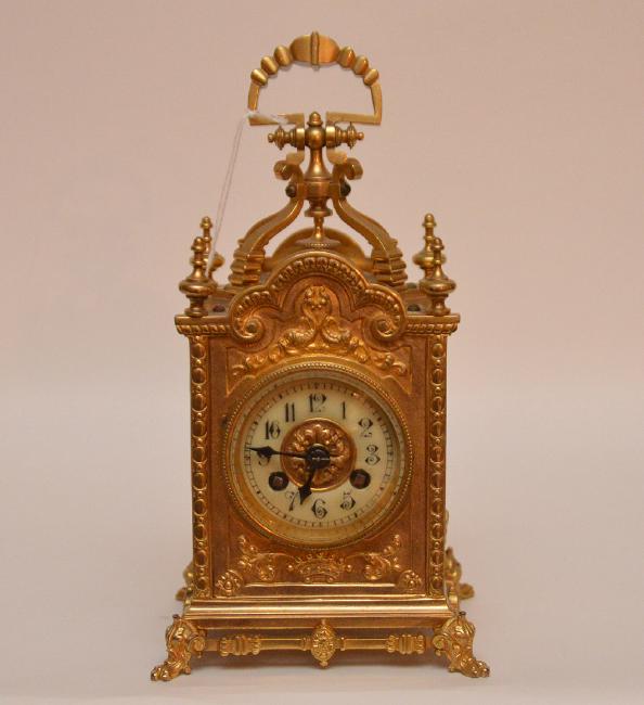 Gilt Bronze Carriage Clock with swing handle.  Raised