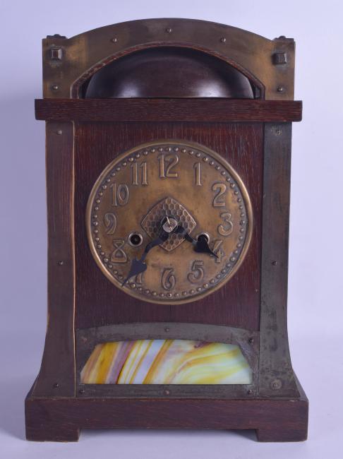 A STYLISH ARTS AND CRAFTS OAK AND BRASS MANTEL CLOCK