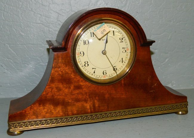 8 day mahogany inlaid clock w/ brass apron.