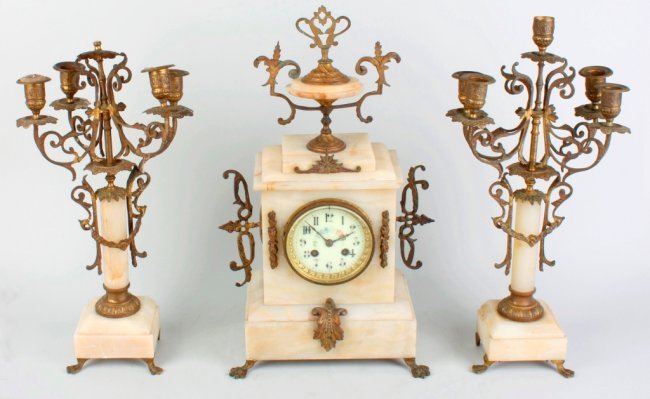 A late 19th century French white onyx clock garnit