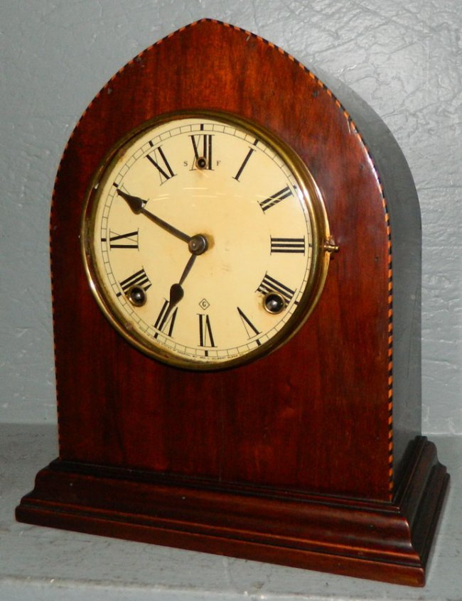 Gilbert inlaid eight day steeple clock .