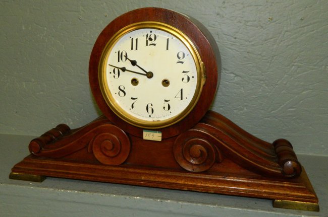 Waterbury mahogany clock w/ porcelain dial.