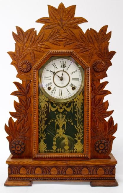 Early 20th century pressed Oak case ‘Laurel’ model gingerbread clock, by Gilbert Clock Co