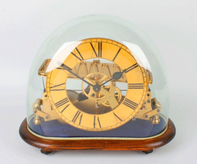 An unsual brass rolling ball skeleton clock