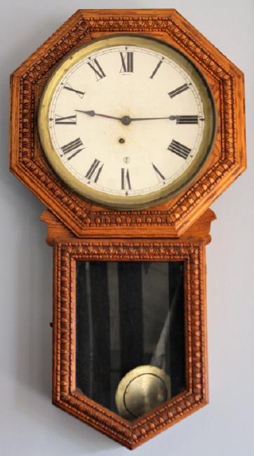 Early 20th century American wall clock, with stained Oak case