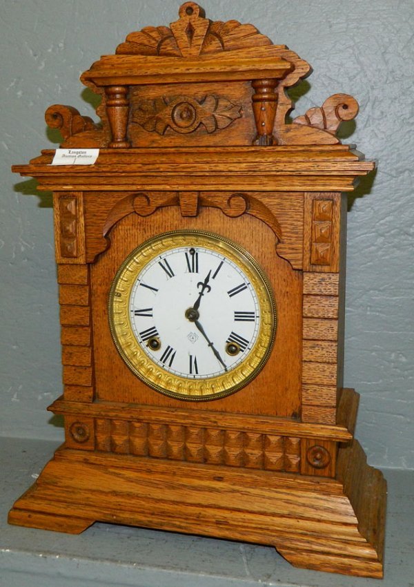 Oak case Ansonia clock with porcelain dial..