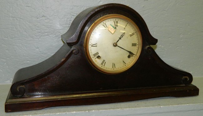 Gilbert cherry 8 day clock w/scrolled shoulders.