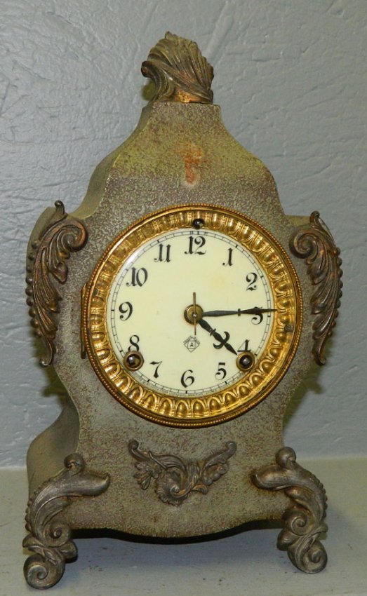 Ansonia lyre shaped clock with porcelain dial.