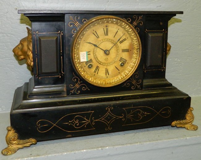 Ansonia  8 day clock w/brass feet & paper dial.