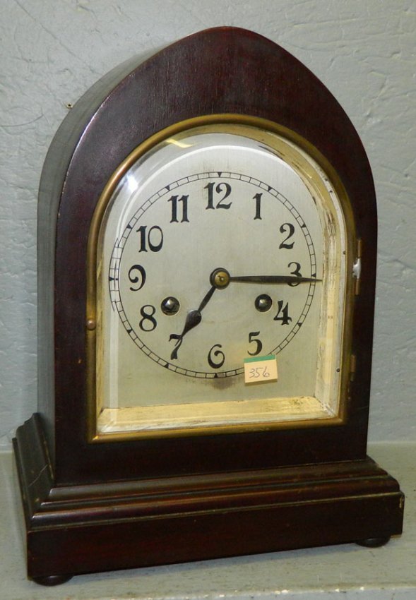 Walnut 8 day clock w/beveled glass & arch top.