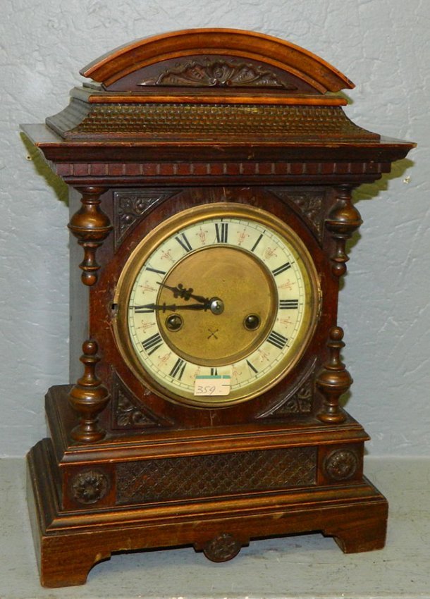 8 day German walnut clock w/ arch top pied.