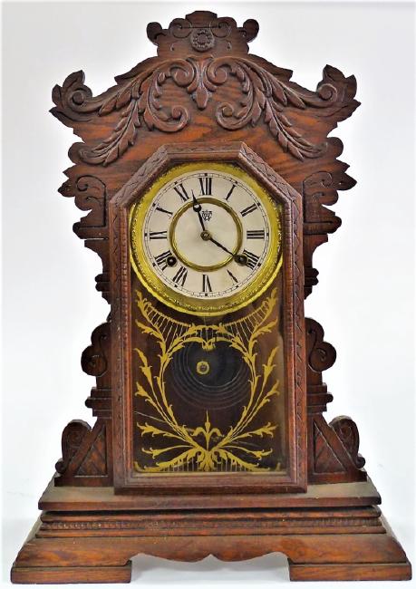 Early 20th century carved Oak case kitchen clock by Waterbury Clock Co