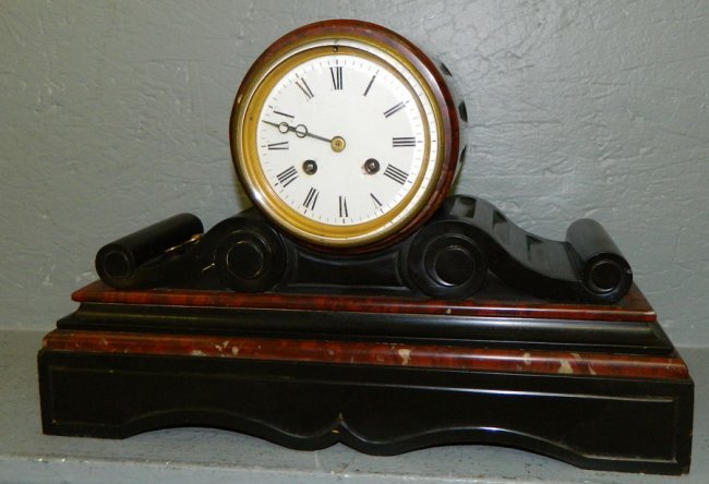 French marble eight day clock with porcelain dial.