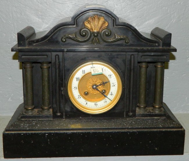 Black marble French mantle clock with columns.