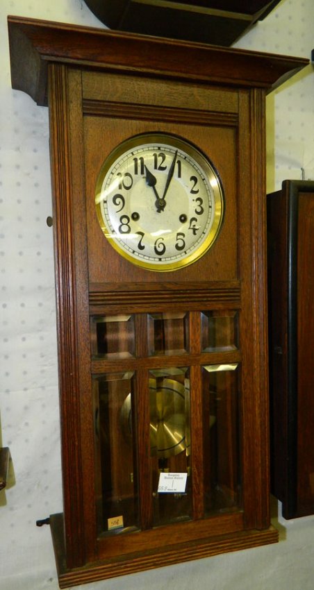 8 day oak pendulum wall clock w/ beveled glass.