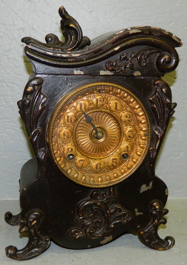 Ansonia metal case clock w/Victorian decoration.