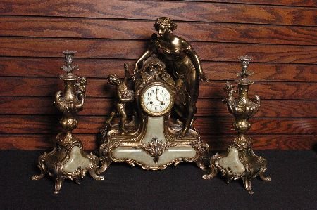 A DRAMATIC FRENCH ART NOUVEAU CLOCK SET WITH ONYX