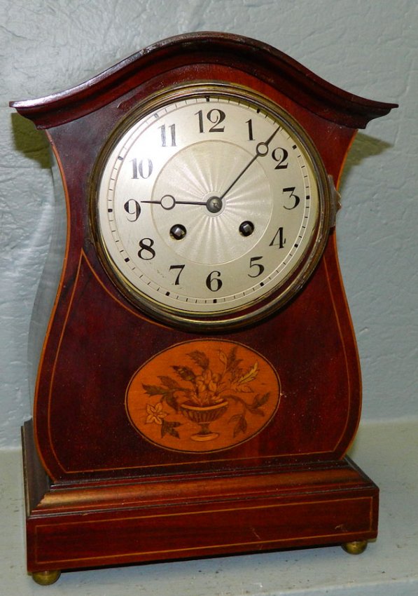 Inlaid mahogany clock with Gothic style case.