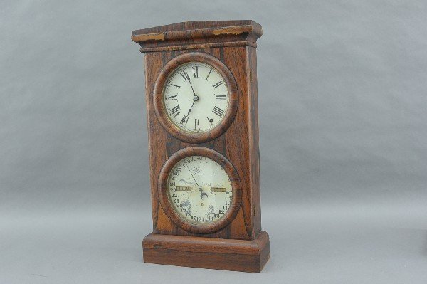 A SETH THOMAS ROSEWOOD CASE DOUBLE DIAL CALENDAR CLOCK