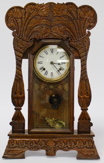 Late 19th century pressed Oak case gingerbread clock by New Haven Clock Co