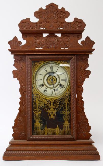 Late 19th century pressed Oak case gingerbread clock by New Haven Clock Co