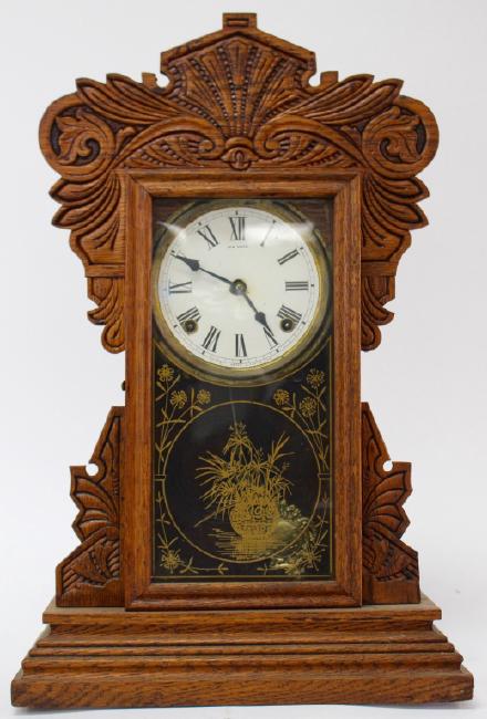 Late 19th century pressed Oak case gingerbread clock by New Haven Clock Co