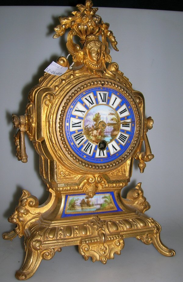 A FRENCH GILT METAL MANTEL CLOCK