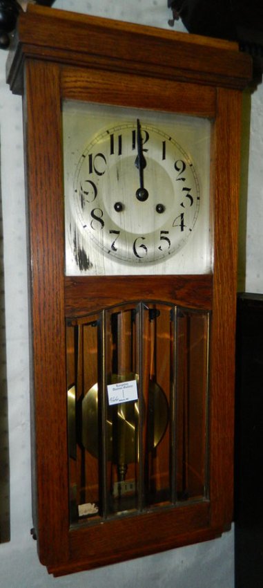 8 day German oak wall clock w/ brass pendulum.