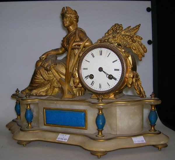 A GILT BRACKET CLOCK WITH A RECLINING FIGURE, AND