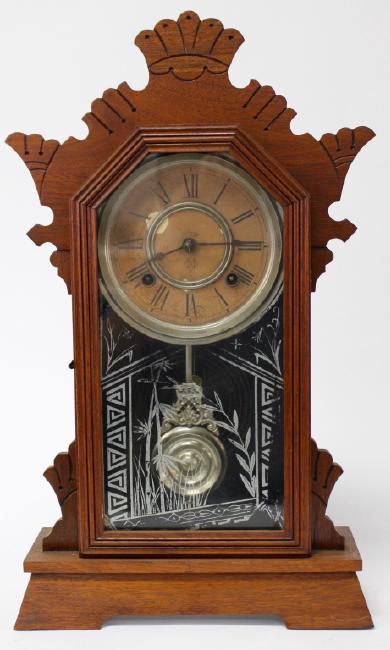 Late 19th century stained Walnut case kitchen clock by Ansonia Clock Co