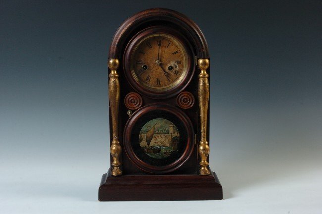 AN INGRAHAM ROUND TOP SHELF CLOCK