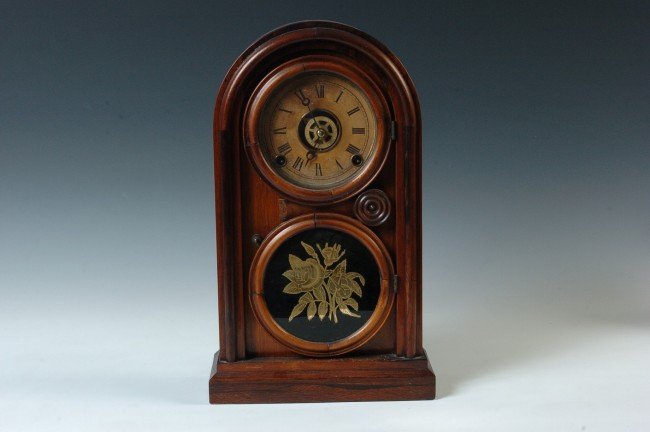 AN INGRAHAM ‘VENETIAN’ ROUND TOP SHELF CLOCK