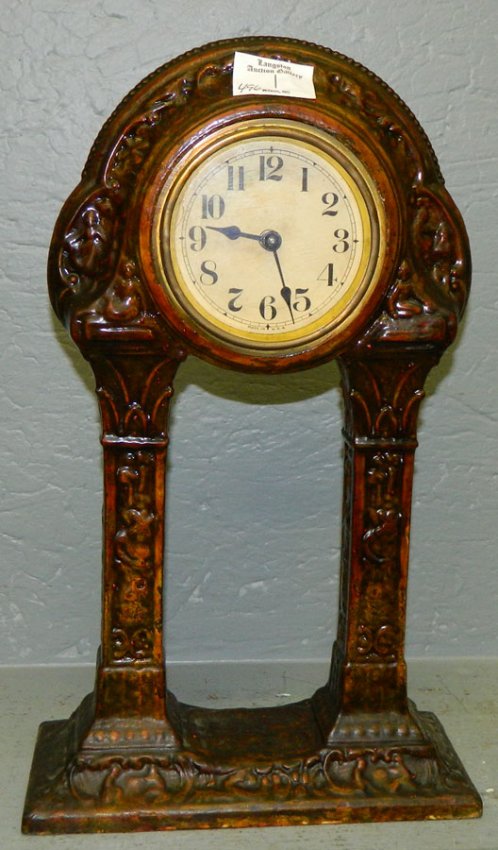 Cast metal American clock in archway design.