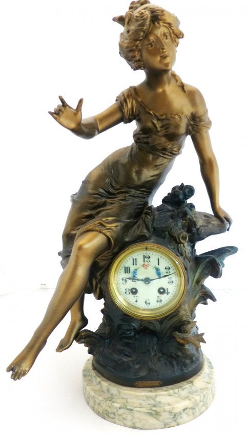 Large Figural clock with maiden sitting on side of