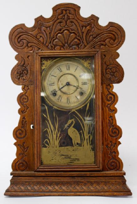 Late 19th to Early 20th century American pressed Oak case gingerbread clock