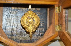 Oak Octogon Short Drape Clock. T/O, unsigned 10″ paper