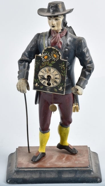 FIGURAL CAST METAL CLOCK VENDOR