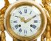 A French gilt-bronze and marble mantel clock retailed