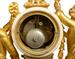 A French gilt-bronze and marble mantel clock retailed