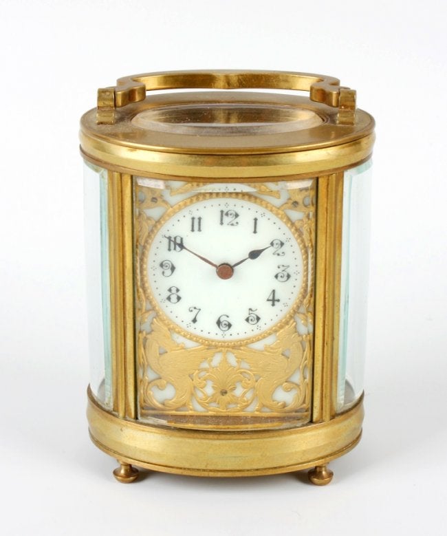 A brass oval carriage clock