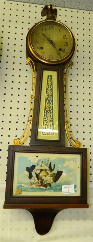 Mahog. 8 day banjo clock w/ship & eagle detail.