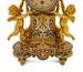 A French Gilt Bronze and Champleve Figural Mantel Clock