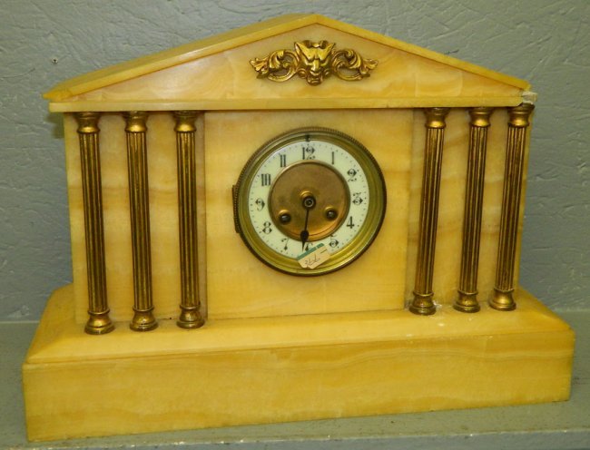 White onyx 8 day clock w/ brass columns.