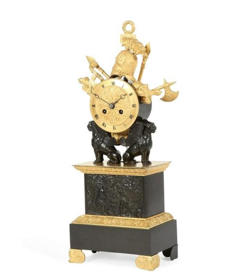 A Charles X bronze military trophy mantel clock